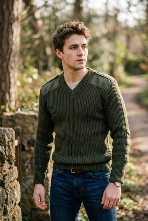 Green sweater with shoulder pads on a white background