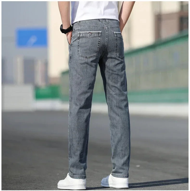 Person wearing gray jeans with a blurred background