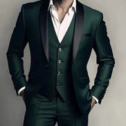 Man wearing a dark green suit with a white shirt against a neutral background
