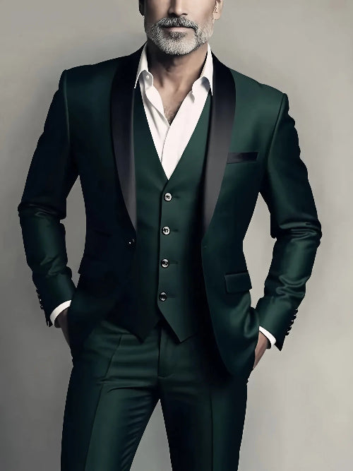 Man wearing a dark green suit with a white shirt against a neutral background