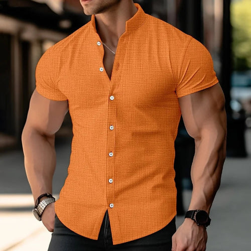 Man wearing an orange short-sleeve shirt with a blurred background
