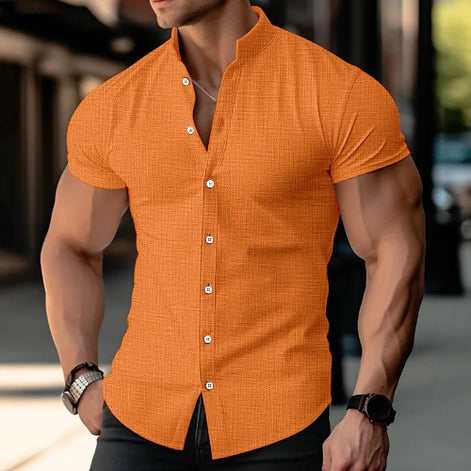 Man wearing an orange short-sleeve shirt with a blurred background