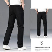 Black straight-leg jeans shown on a model from the back, with a main large view and a smaller inset view. The model is wearing a white t-shirt and white sneakers 