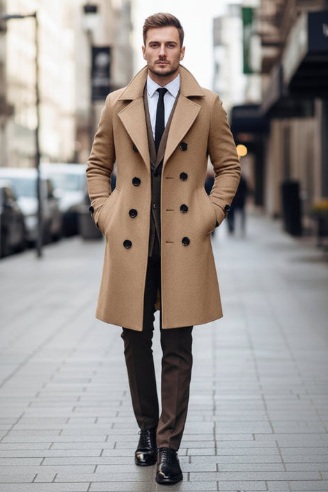 Man wearing a beige overcoat with a blurred city street background