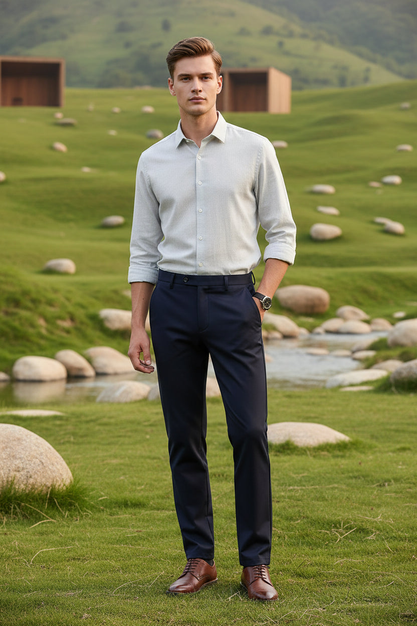 Person wearing navy blue dress pants on a white background