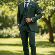 Green suit with striped tie and pocket square on a white background