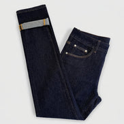 Dark indigo blue jeans folded on a white background, showing the front pocket, belt loop, and rolled cuff revealing a lighter gray inner lining.