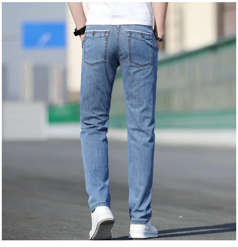 Person wearing light blue jeans with a blurred background