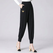 Black pants worn by a person on a dark background