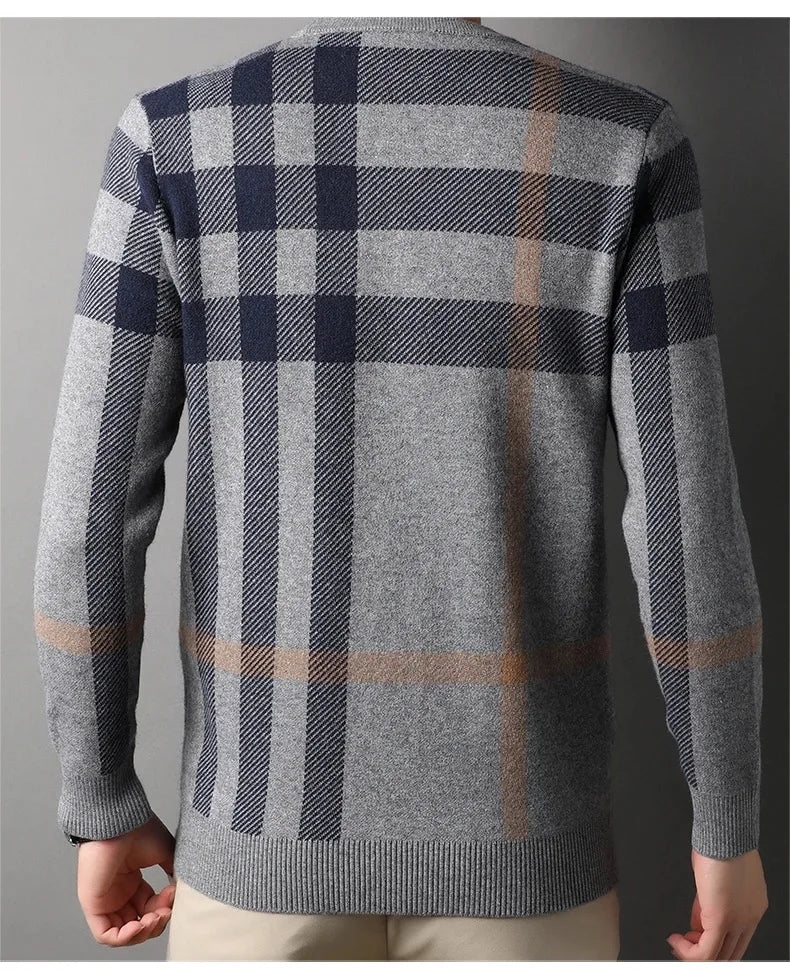 Plaid sweater with a gray and navy pattern on a plain background