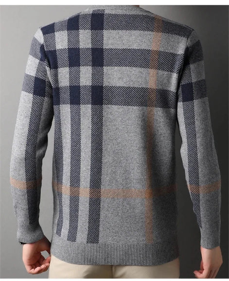 Plaid sweater with a gray and navy pattern on a plain background