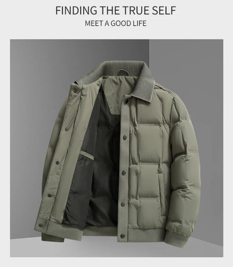 A men's puffer jacket in muted sage green, shown open to reveal a black interior lining. The jacket features a ribbed collar, cuffs, and hem, and is displayed against a gray background with promotional text at the top.