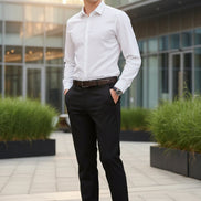 Black dress pants worn with a white shirt and brown shoes on a gray background