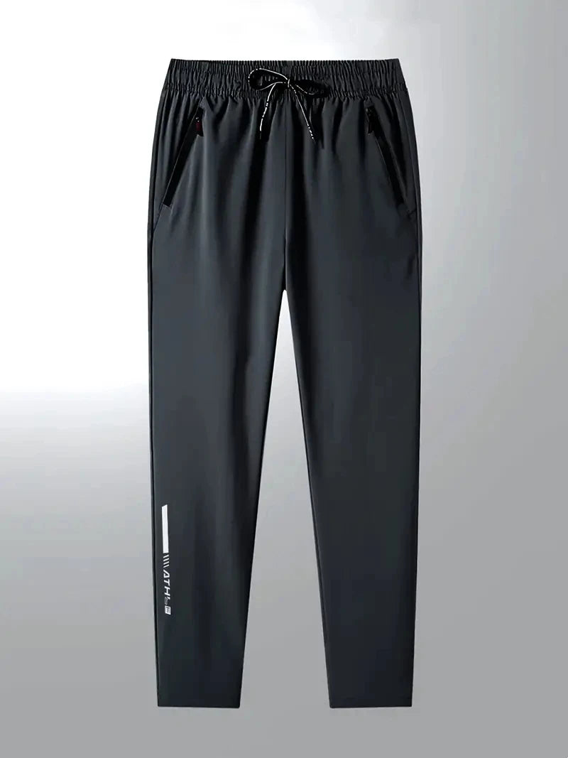 Black pants with a small white logo on a gray background