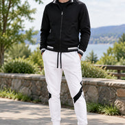 Black jacket and white pants with black accents on a white background