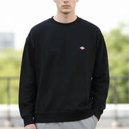 Black sweatshirt with a small red logo on a white background