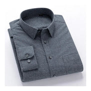 A folded long-sleeve button-up dress shirt with a fine micro-check pattern in dark gray and black, featuring a classic collar and a buttoned chest pocket.