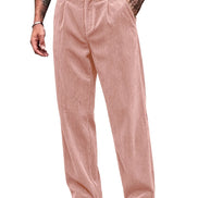 A person wearing dusty pink corduroy trousers with a black belt, paired with black and white shoes, shown from the waist down on a white background.