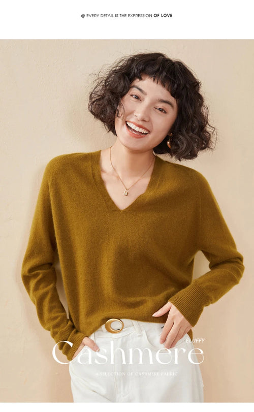 Woman wearing a mustard yellow cashmere sweater on a beige background