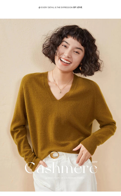 Woman wearing a mustard yellow cashmere sweater on a beige background