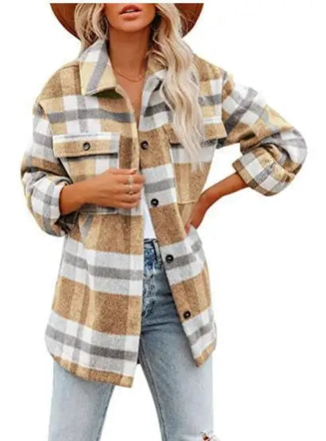 Woman wearing a tan and gray plaid shirt with jeans, against a white background.
