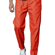 A person wearing bright orange-red tapered pants with a dark gray shirt and white sneakers, 