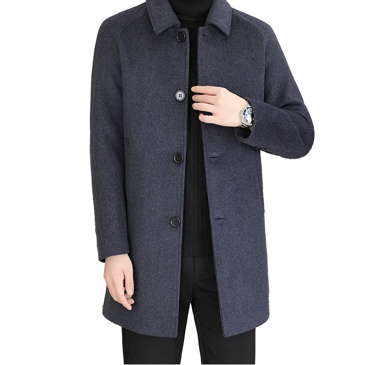 A man wearing a dark navy blue wool-blend coat over a black turtleneck sweater and black pants, shown from the chin down against a plain white background.
