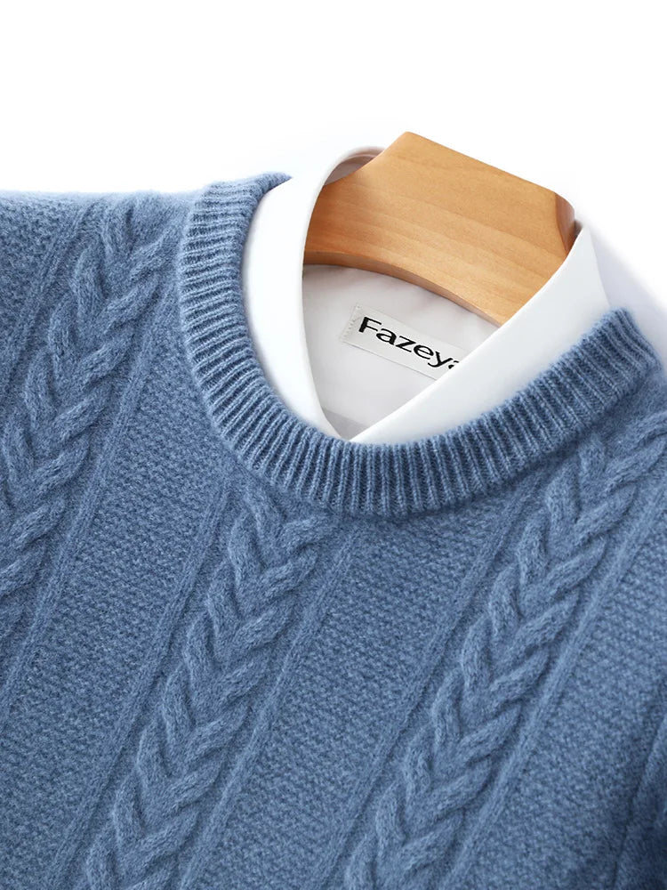 Blue cable knit sweater on a wooden hanger with 'Fazey' label.