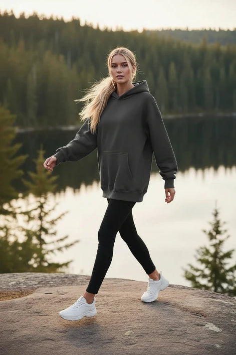 Gray hoodie worn by a person on a white background