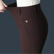 Brown pants with a decorative brooch on a dark background
