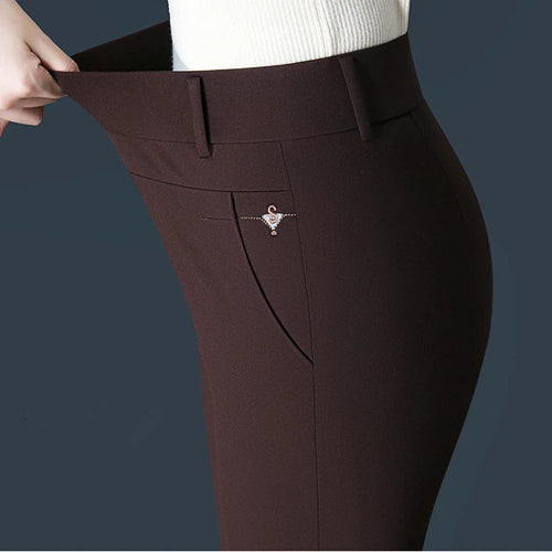 Brown pants with a decorative brooch on a dark background