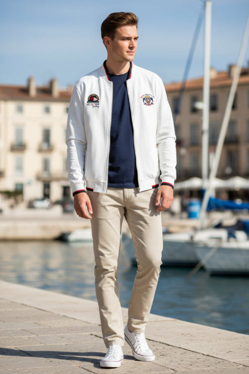 White jacket with logos on a white background, featuring the Tace&Shark brand.