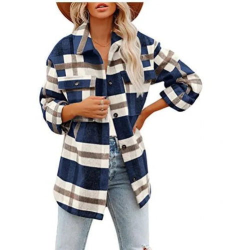 Woman wearing a navy and white plaid shirt with gray accents and jeans.