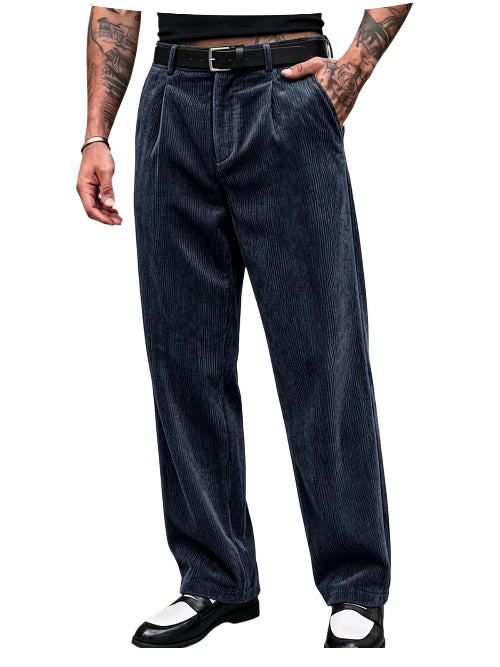 A person wearing dark navy corduroy trousers with a black belt, shown from the waist down against a plain white background.