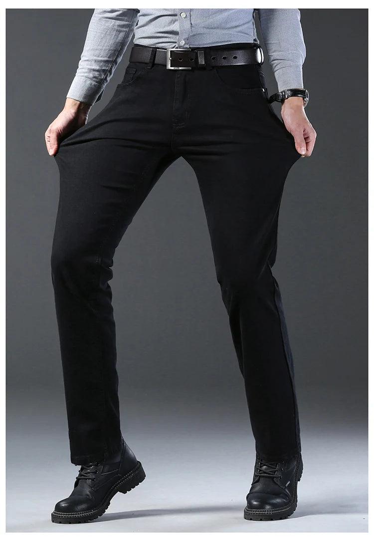 Person wearing black pants with a gray background