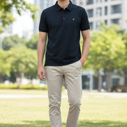 Dark gray polo shirt with red stitching on a hanger, held by a hand.