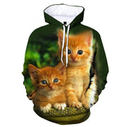 A dark green pullover hoodie featuring a large, realistic all-over print of two orange kittens sitting together, with a white hood lining and white drawstrings.
