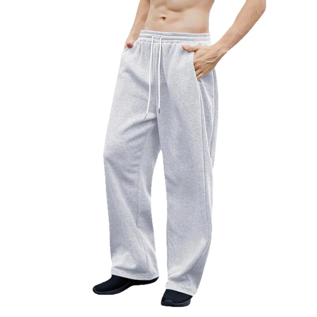 Gray sweatpants worn by a person on a white background
