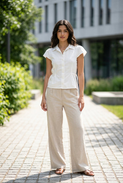 White blouse with ruffled sleeves on a light gray background
