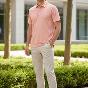 Pink polo shirt on a white background