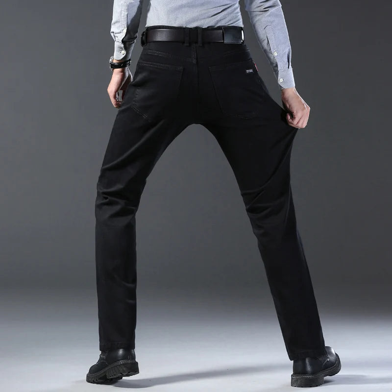 Person wearing black pants on a gray background