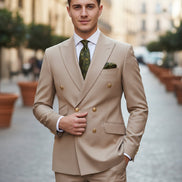 Beige suit with matching jacket and pants on a mannequin, featuring a green tie and pocket square.