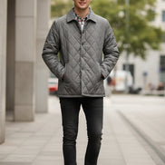 Gray quilted men's jacket with an open plaid lining in white, blue, and red, shown on a white background with a feature callout graphic on the left.