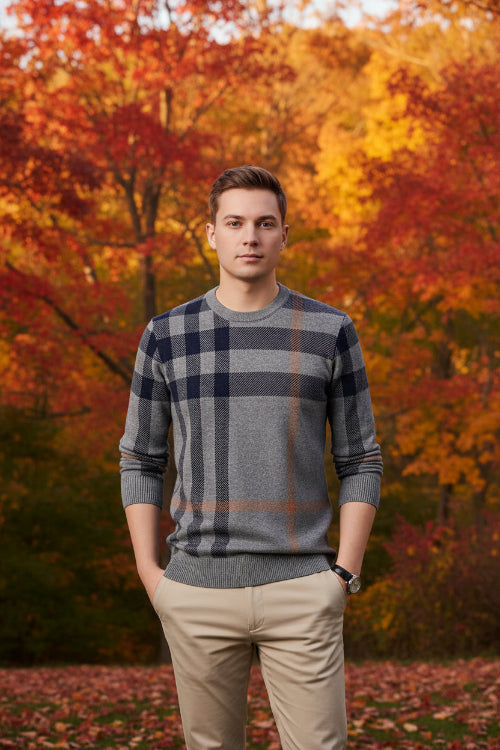 Person wearing a gray and navy plaid sweater against a gray background