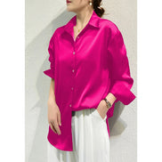 Fuchsia satin blouse worn by a model, shown from the side.