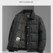 A men's black puffer jacket with a ribbed collar, snap-button front, and ribbed cuffs and hem, displayed against a gray background with promotional text at the top.