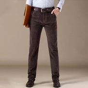 Person wearing brown pants with a plain background