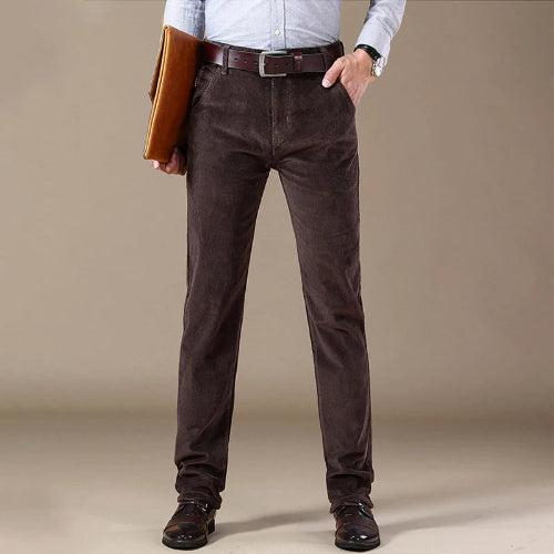 Person wearing brown pants with a plain background