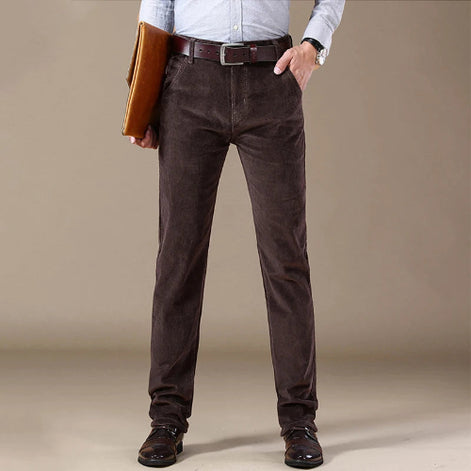 Person wearing brown pants with a plain background