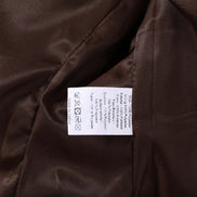 Close-up of the jacket's care label showing 100% polyester shell and lining, care symbols and made-in-China information⠋